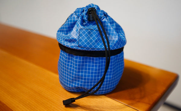 A Small Travel Tray with the top flipped up and the pull cord tightened.